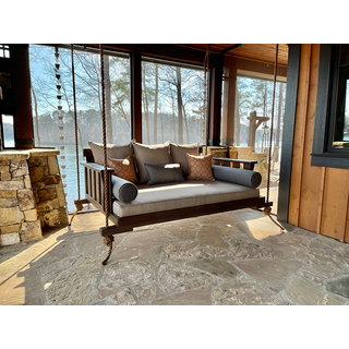 Cabana Bed Swing with a full size mattress.  The frame has a dark colored finish on it and neutral cushions complete the look.